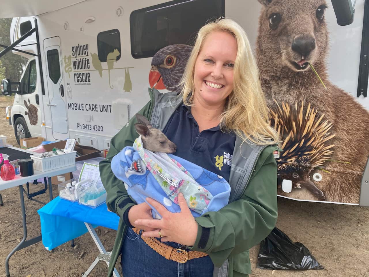 Sydney Wildlife volunteer Lynleigh Greig with an orphaned joey.