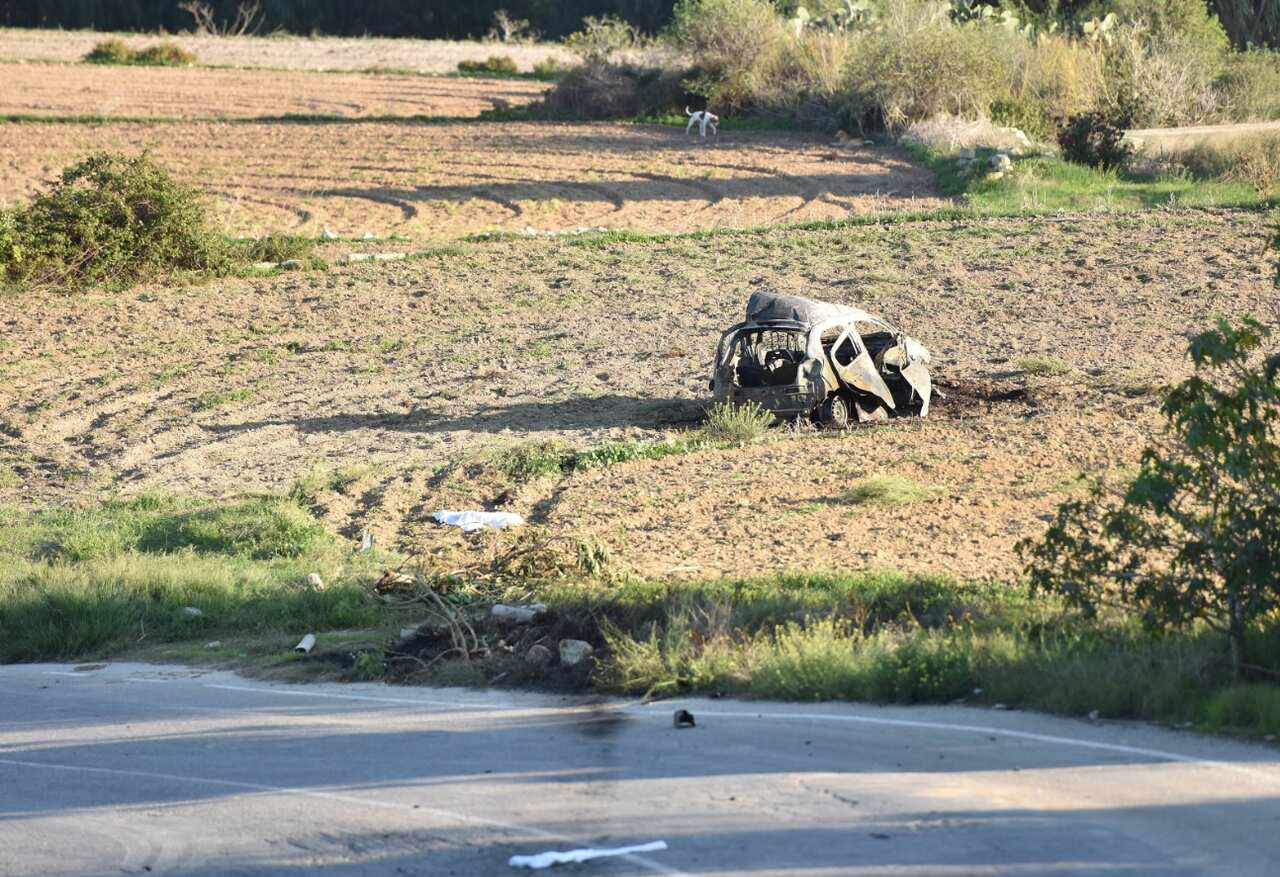 The wreckage of the car of investigative journalist Daphne Caruana Galizia lies next to a road in the town of Mosta, Malta, Monday, Oct. 16, 2017 (AAP)