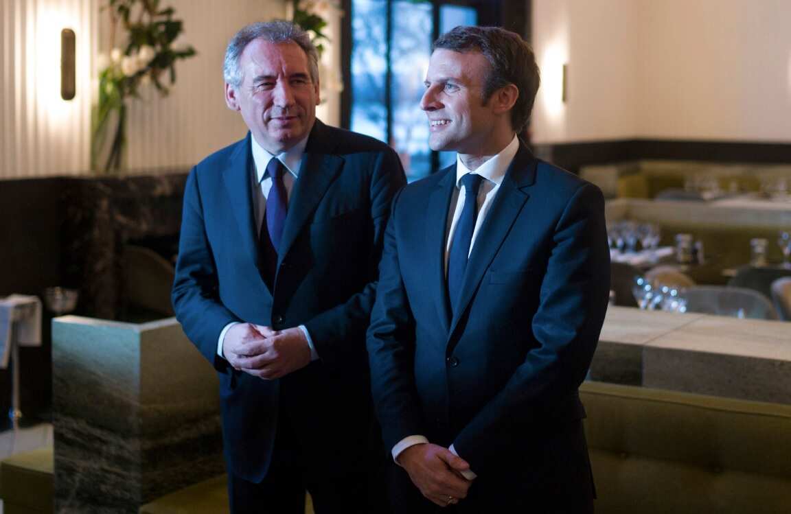 Francois Bayrou, left, and Emmanuel Macron, pose for photographers after their meeting on Thursday in Paris.