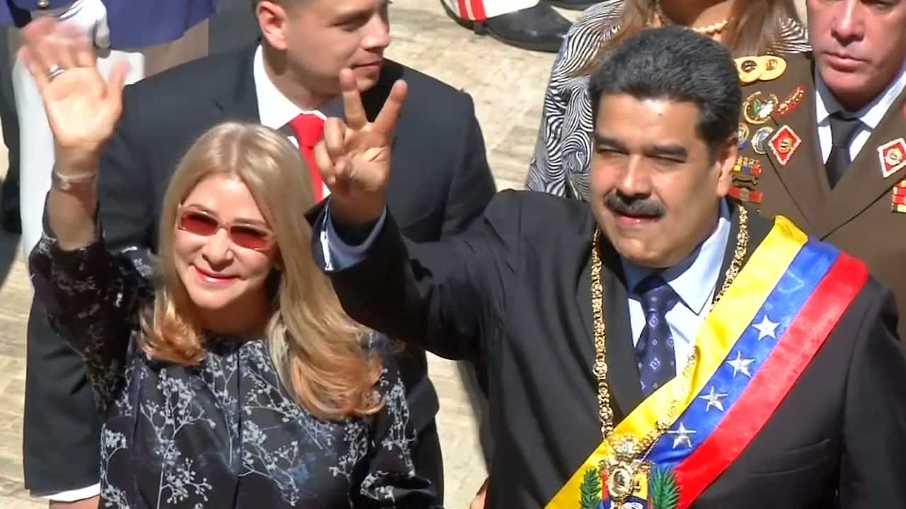 Venezuelan President Nicolas Maduro makes the peace sign.