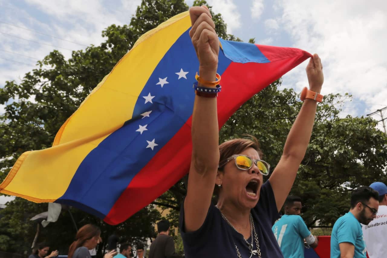 Opponents of Venezuelan President Nicolas Maduro protest the previous day's presidential election which Maduro won