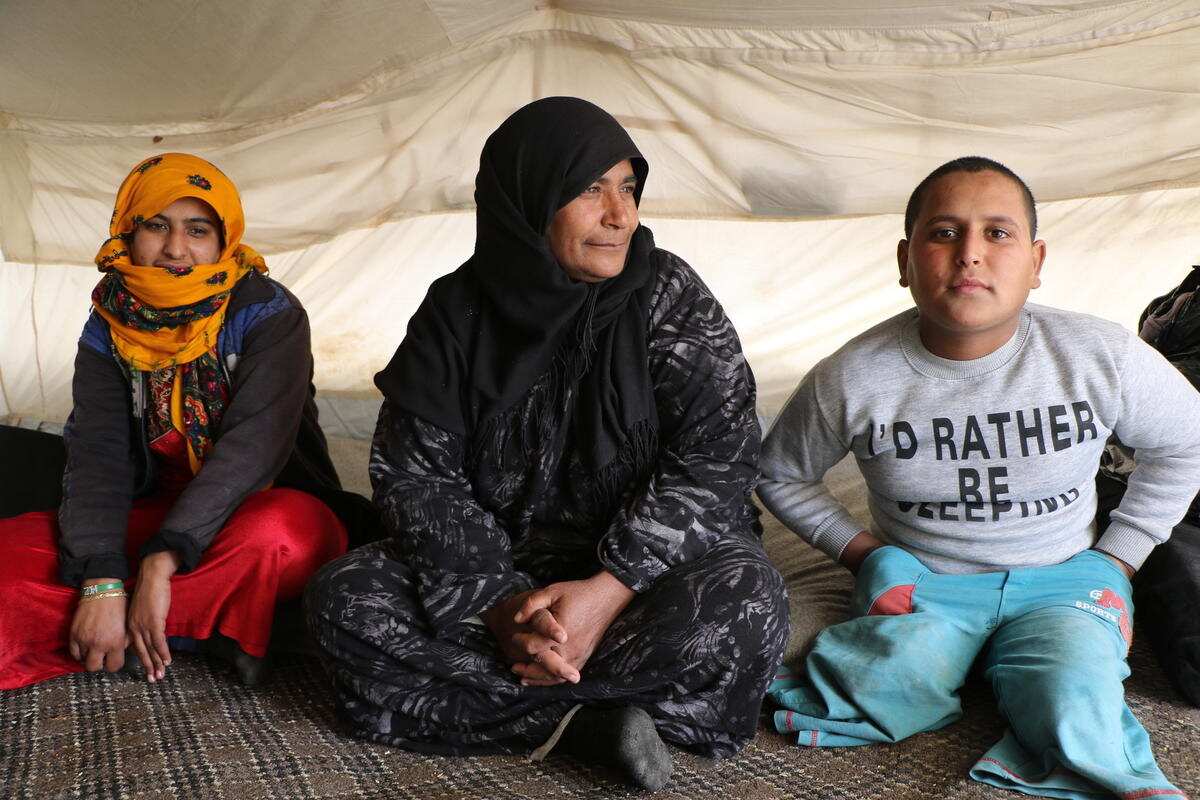 Mahmoud and his family in a tent. 