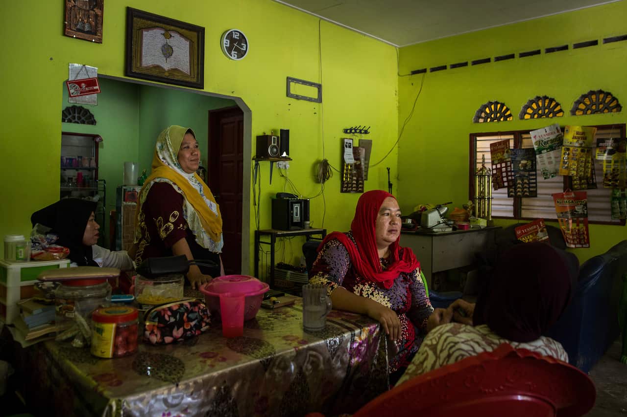 Nuraini Che Nawi, right, the first wife of Che Abdul Karim Che Abdul Hamid, at her family's restaurant in Gua Musang, Malaysia.
