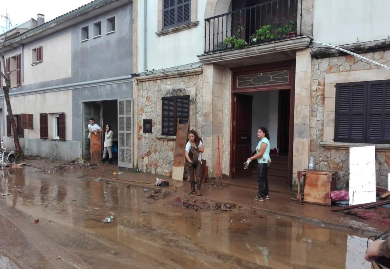 People clean the mud from their houses in Sant Llorenc, the town hardest hit by the downpours located 60km east of Mallorca's capital