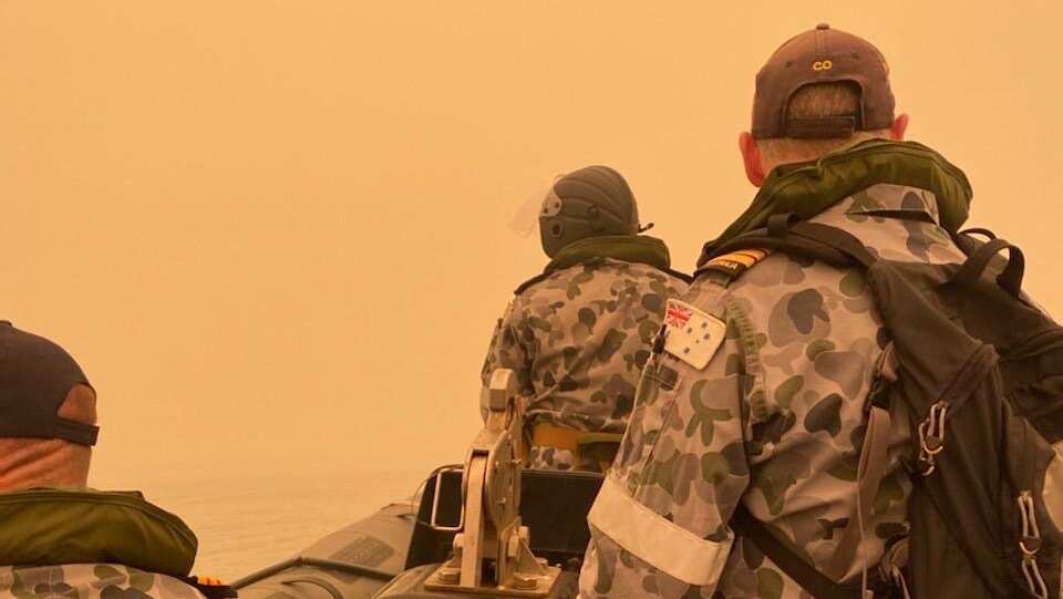 The Commanding Officer of HMAS Choules, Scott Houlihan, leading a liaison team to meet with community leaders in Mallacoota, Victoria.