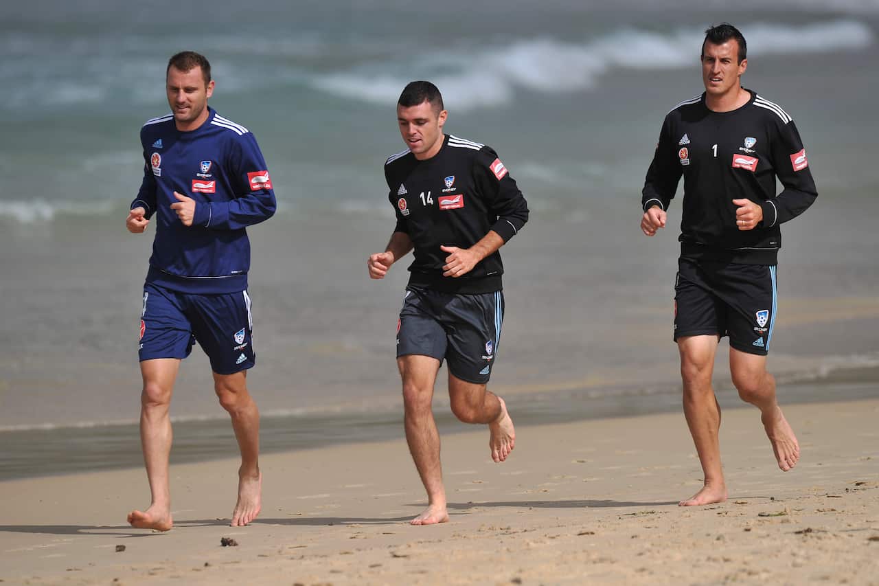 Sydney FC players (L to R) Ranko Despotovic, Mitch Mallia and Ivan Necevski attend a recovery session at Bondi Beach