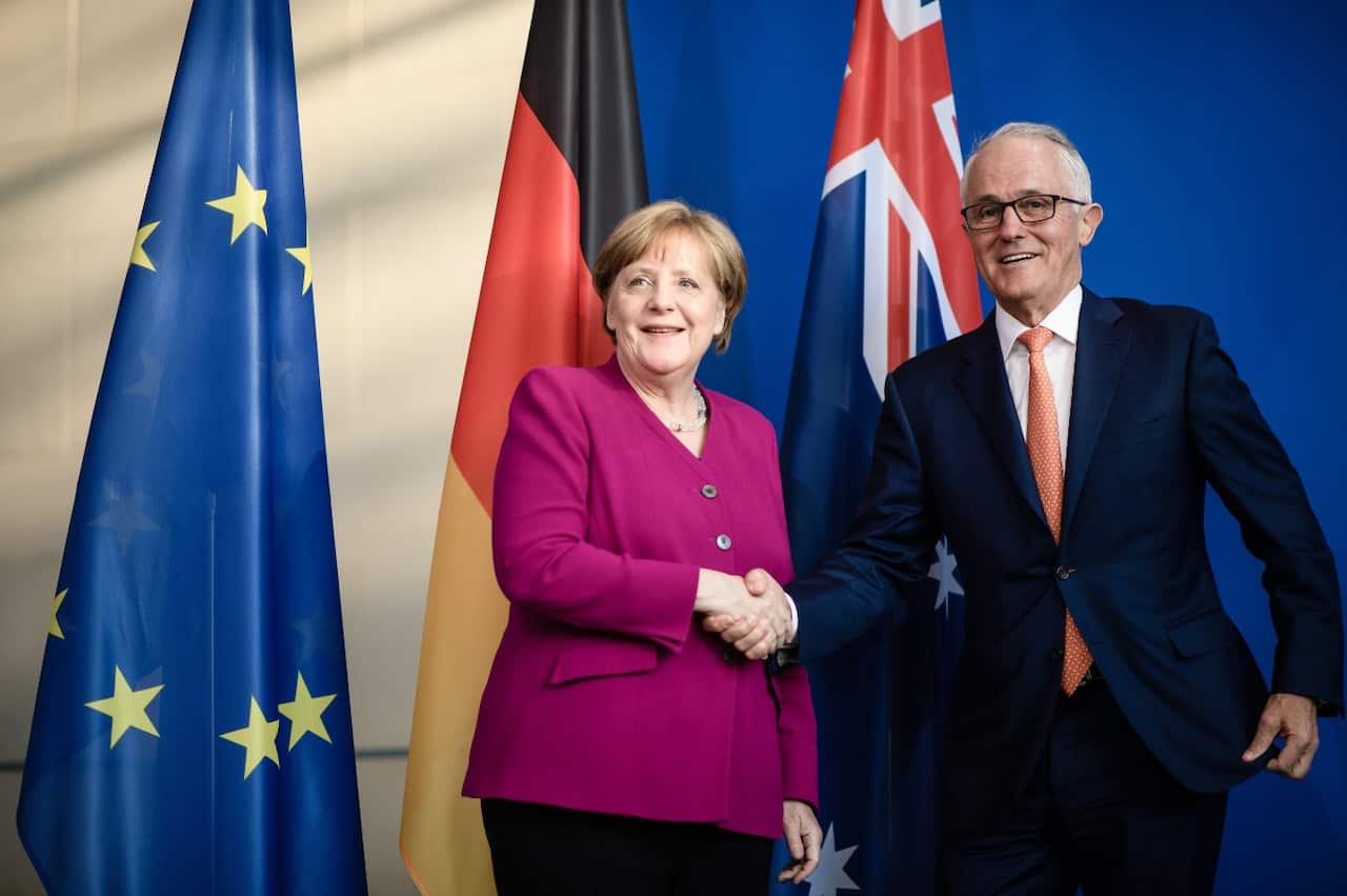 German Chancellor Angela Merkel (L) shakes hands with Australian Prime Minister Malcolm Turnbull (L) during a press statement at the Chancellery in Berlin