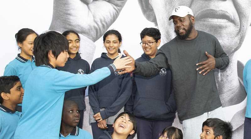 Kweku Mandela meets with Year 6 students as part of a tour of the exhibition.