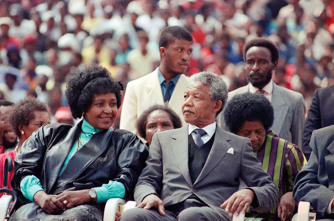 Winnie Mandela with her former husband Nelson Mandela at a rally in Soweto, South Africa in 1990.