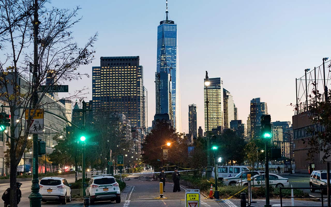 Police stand by as they continue to secure the scene along a bike path after a motorist drove onto the path near the World Trade Center memorial on October 31.