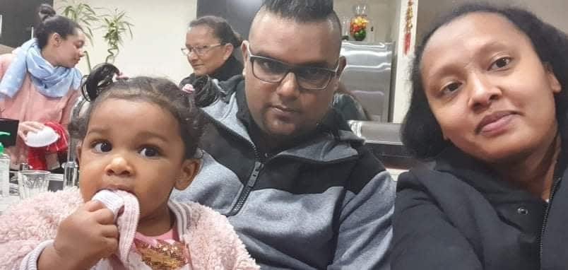 Marie and Rajiv Caussy with their daughter.