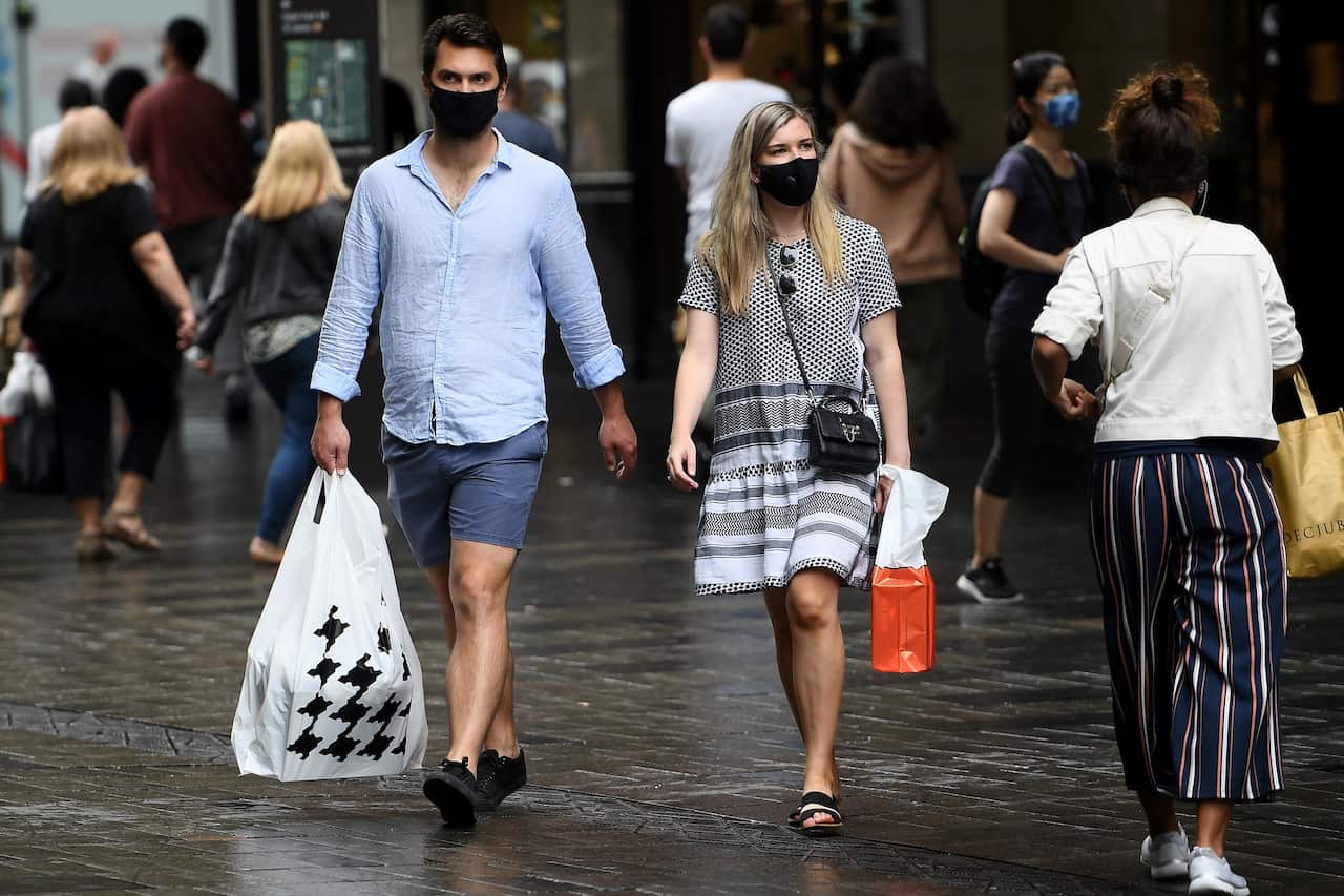 People are seen wearing masks in Sydney.