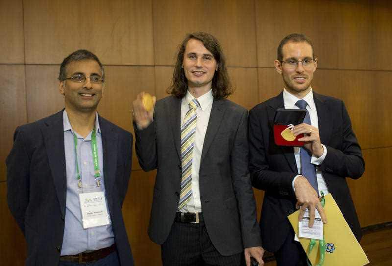 Akshay Venkatesh with Italy's Alessio Figalli, and Germany's Peter Scholze accept their awards.