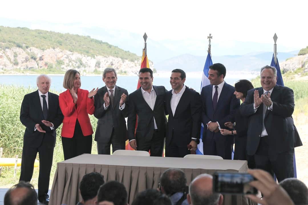 Members of both the Greek and Macedonian government are joined by members of the UN and EU.