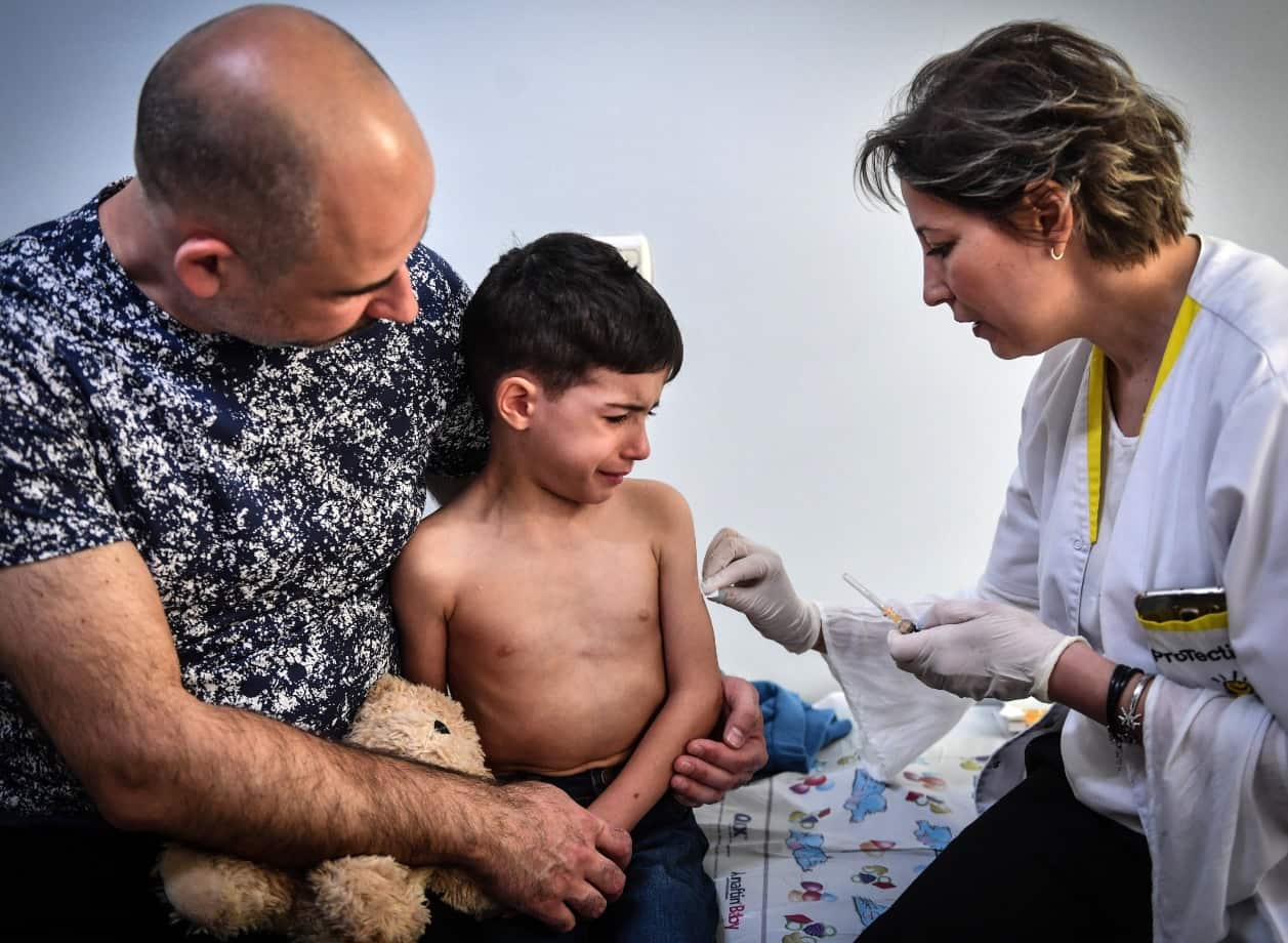A child receives a vaccination against measles by a family physician on April 16, 2018 in the Romanian capital, Bucharest.