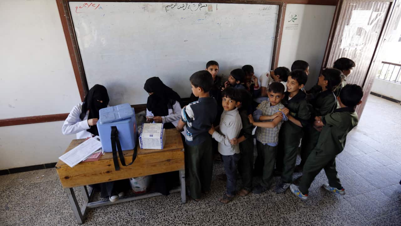 Yemeni students wait to get vaccinated during a week-long vaccination campaign against measles at a school amid a rapidly spreading outbreak.