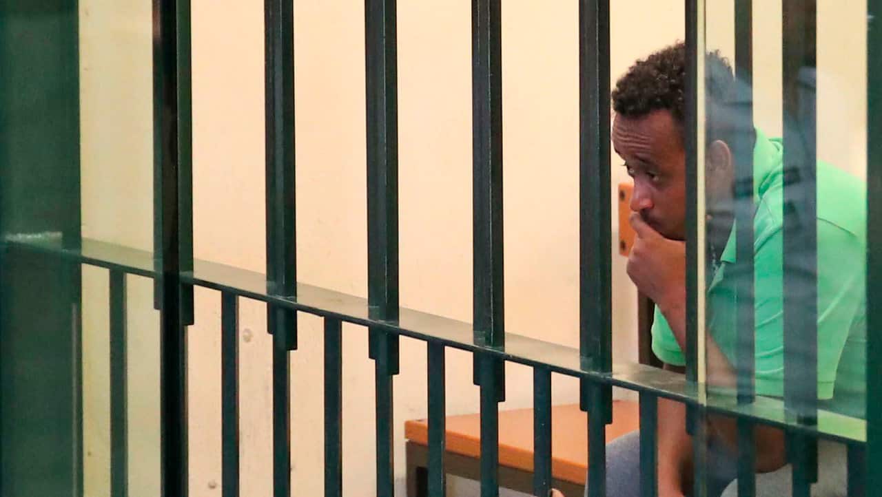 Medhane Yehdego Mered behind the bars during his trial.