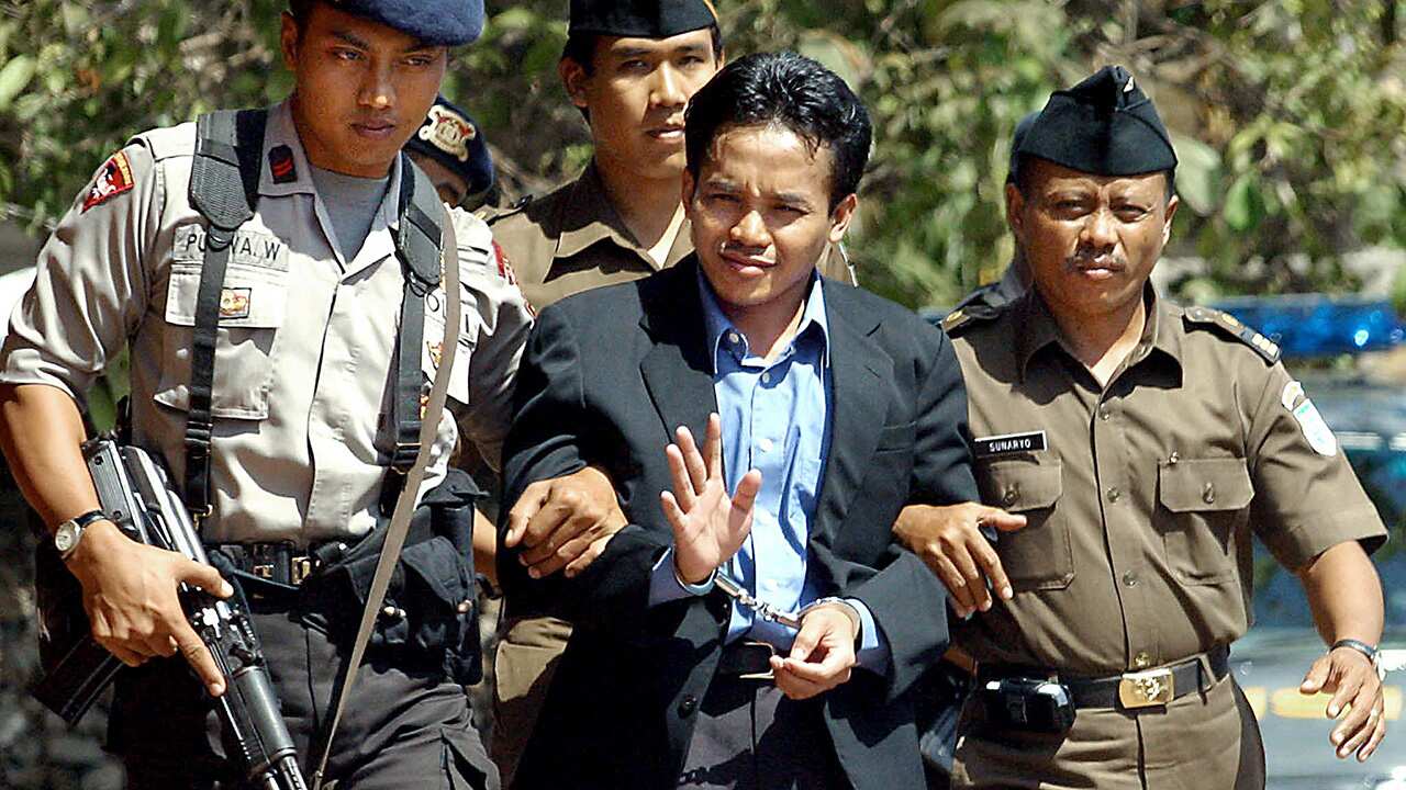 Ali Imron being escorted from court in Bali in 2003.