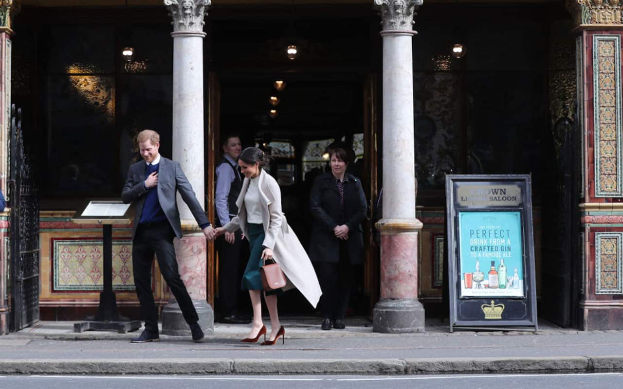 Meghan Markle and Prince Harry leave Crown Bar, a former Victorian gin palace owned by the National Trust, on March 23, 2018 in Belfast, Nothern Ireland
