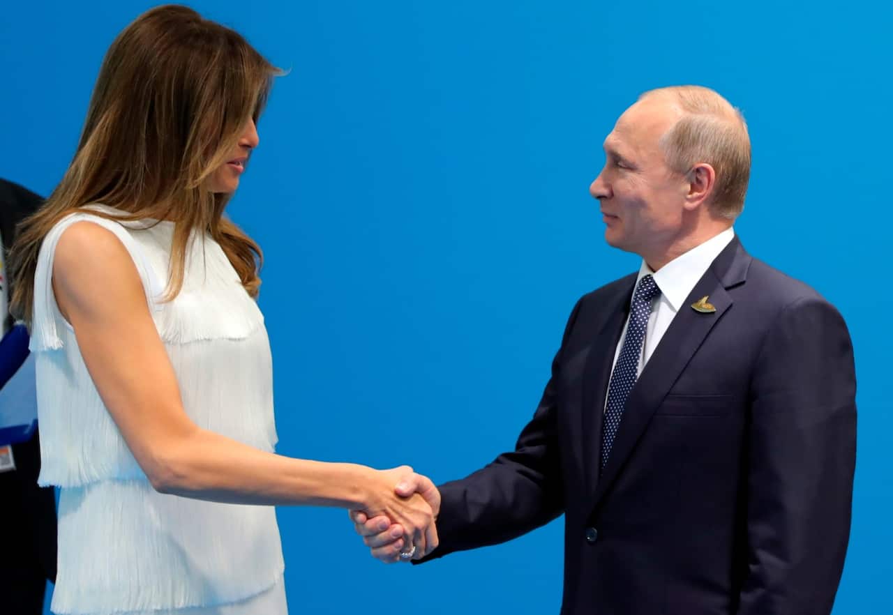 Russian President Vladimir Putin greets US President Donald Trump's wife Melania (AAP)