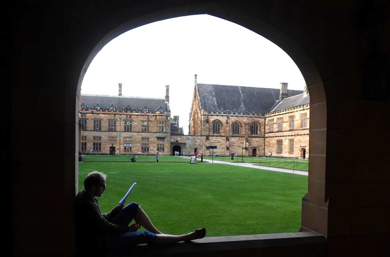 A student reads at the Quadrangle of the University of Sydney