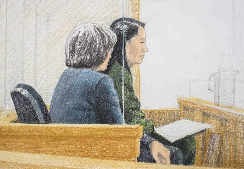In a courtroom sketch, Meng Wanzhou, the chief financial officer of Huawei Technologies, sits beside a translator during a bail hearing.