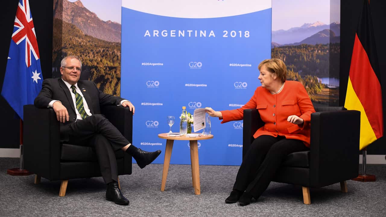 Chancellor of Germany Angela Merkel checks her notes as she sits down for a bilateral meeting with Australian Prime Minister Scott Morrison.