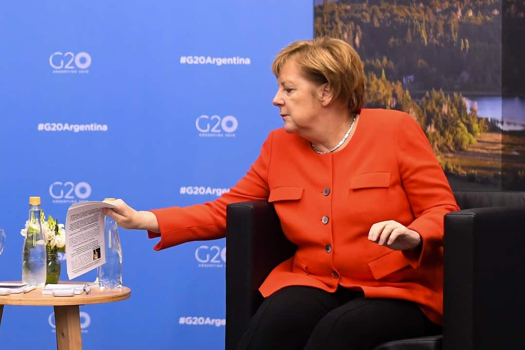 Chancellor of Germany Angela Merkel holds notes with information about her counterpart Australian Prime Minister Scott Morrison.