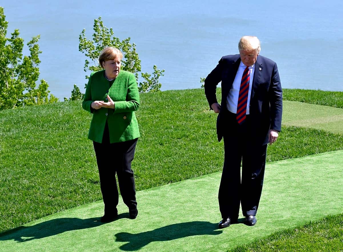 U.S Donald Trump(R) and Germany's Chancellor Angela Merkel leave after taking G7 family photograph prior to the G7 working session 