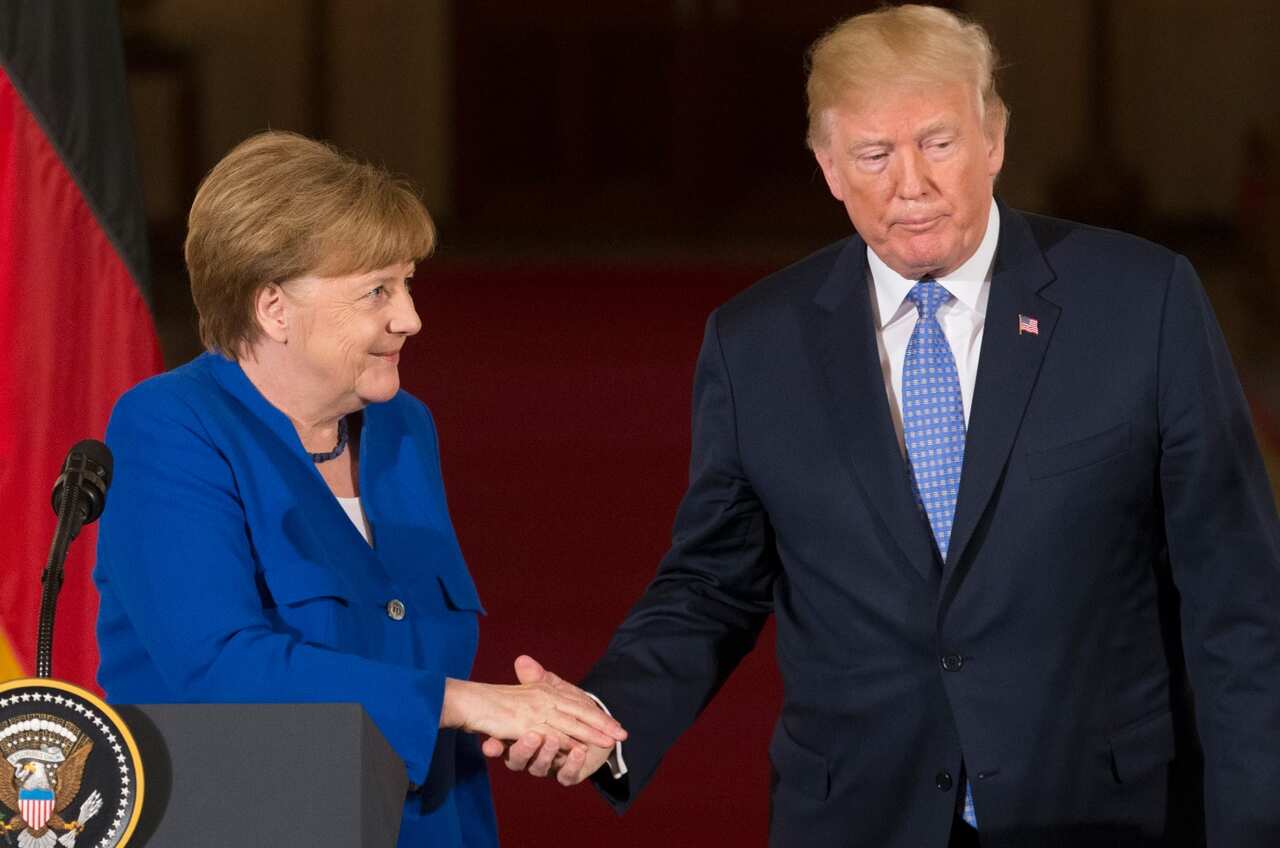 S President Donald J. Trump (R) and Chancellor of Germany Angela Merkel (L) shake hands while holding a joint news conference