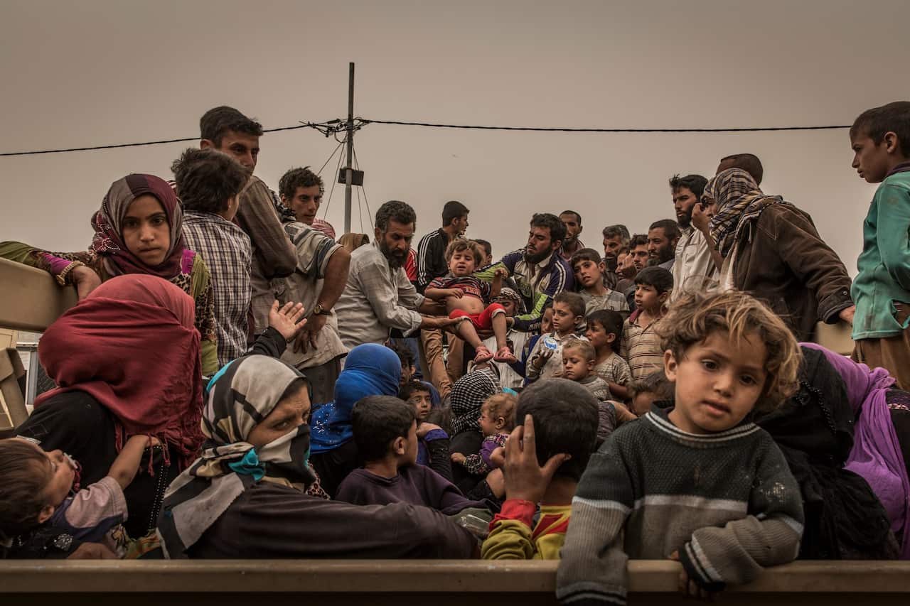 Displaced families at a screening center near Kirkuk, Iraq, after fleeing Islamic State-controlled areas in Hawija in October.