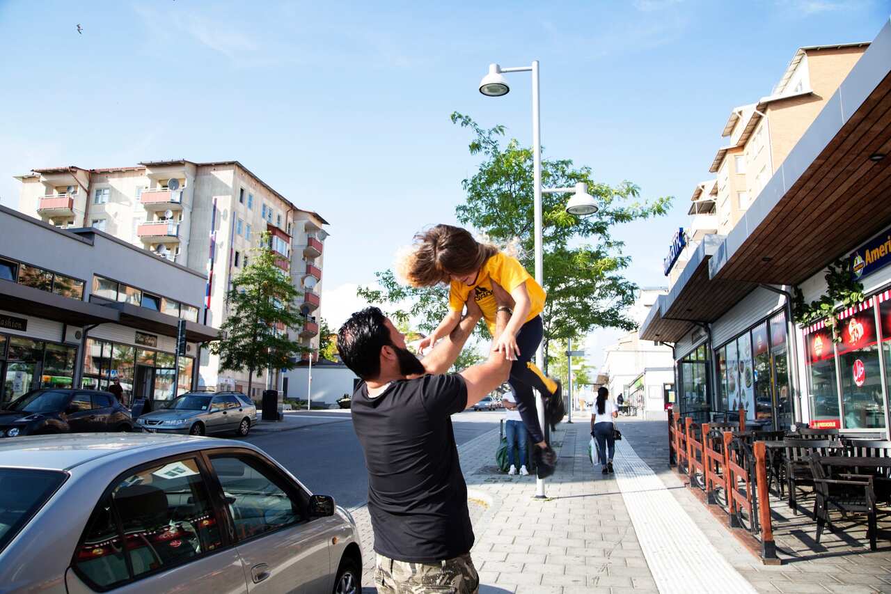 Hani Al Saleh, a guard in Rinkeby known as Amo, or uncle, by local youth, throwing his niece up in the air.