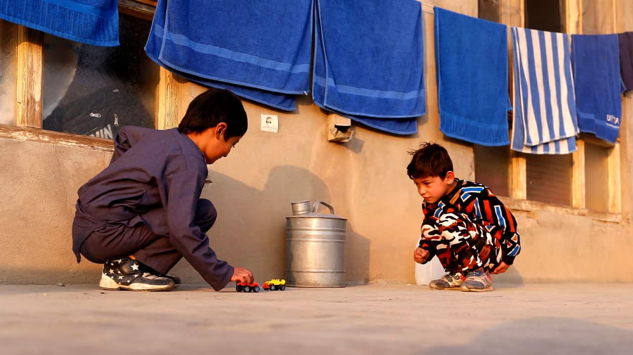 Murtaza Ahmadi, a young fan of Barcelona star Lionel Messi, plays with a friend in Kabul, Afghanistan on 3 December 2018.