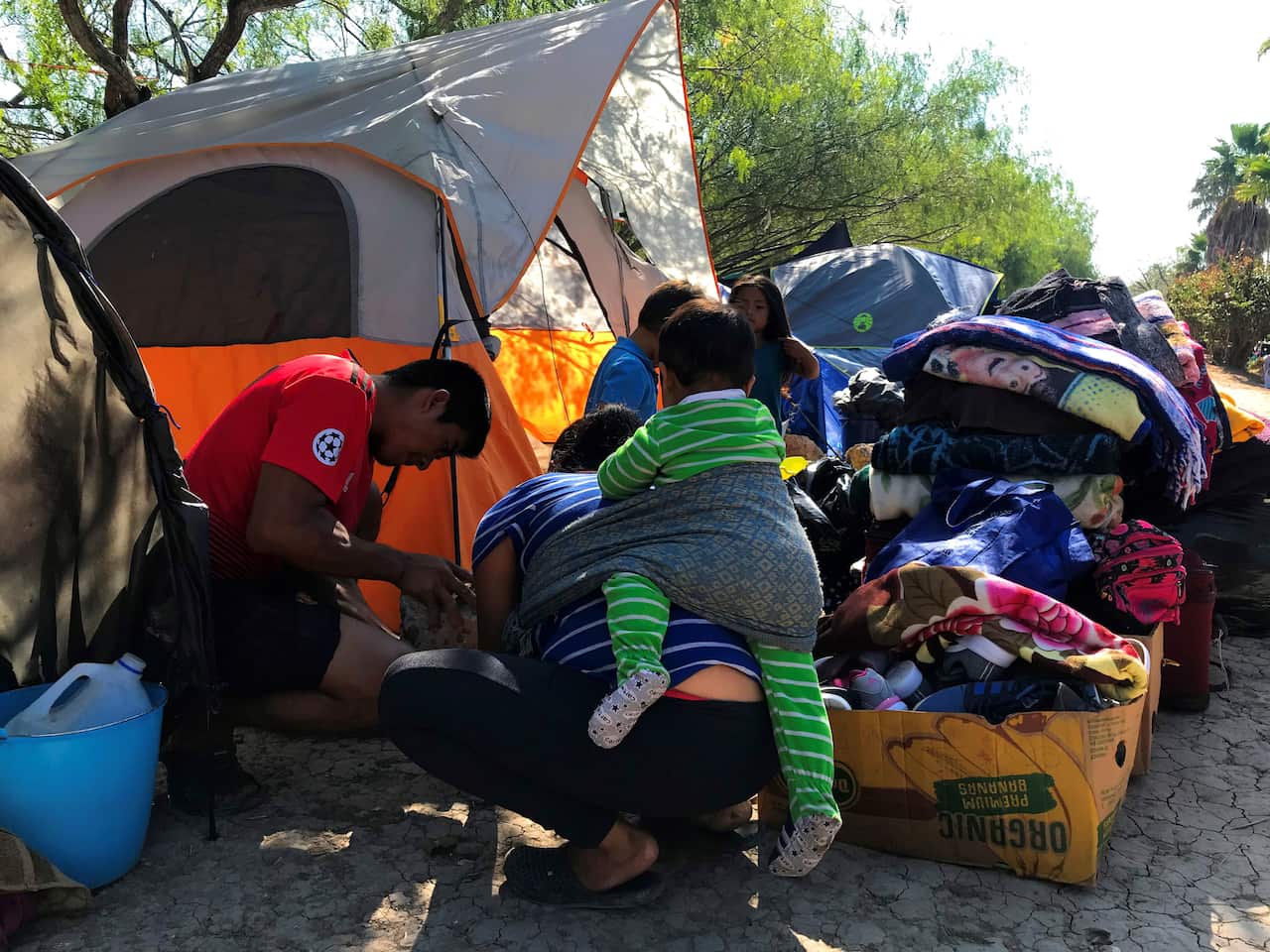 Central American people waiting to cross the border are increasingly feeling the cold, with some forced to live open to the elements. 