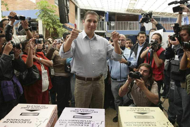 In a 2010 photo Rafael Moreno Valle, then-candidate of the "Compromiso por Puebla" party coalition, flashes two thumbs up after casting his vote.
