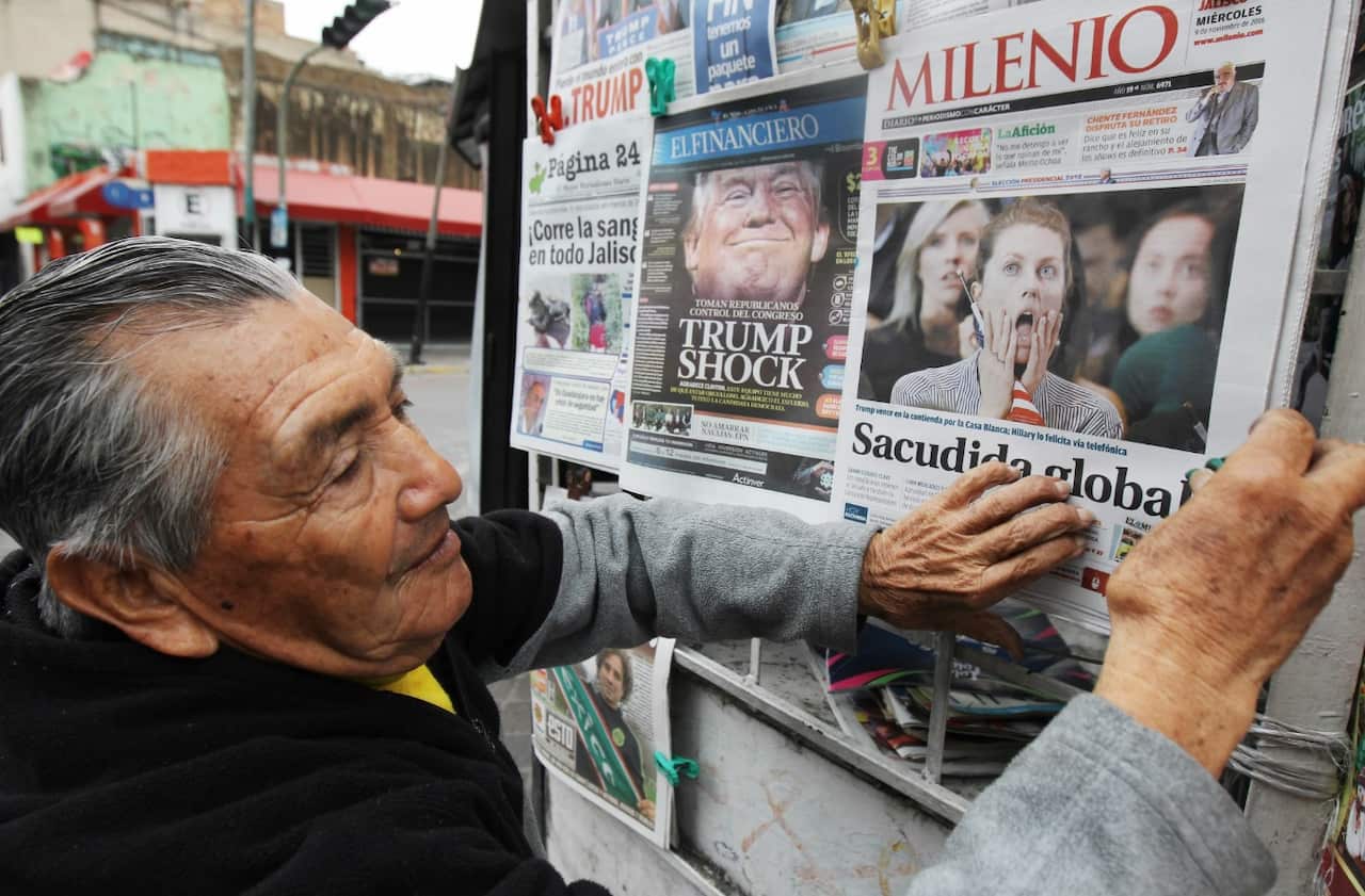 A man sells newspapers showing information about the election of Donald Trump as President of the United States in Guadalajara, Mexico, 09 November 2016. (AAP) 