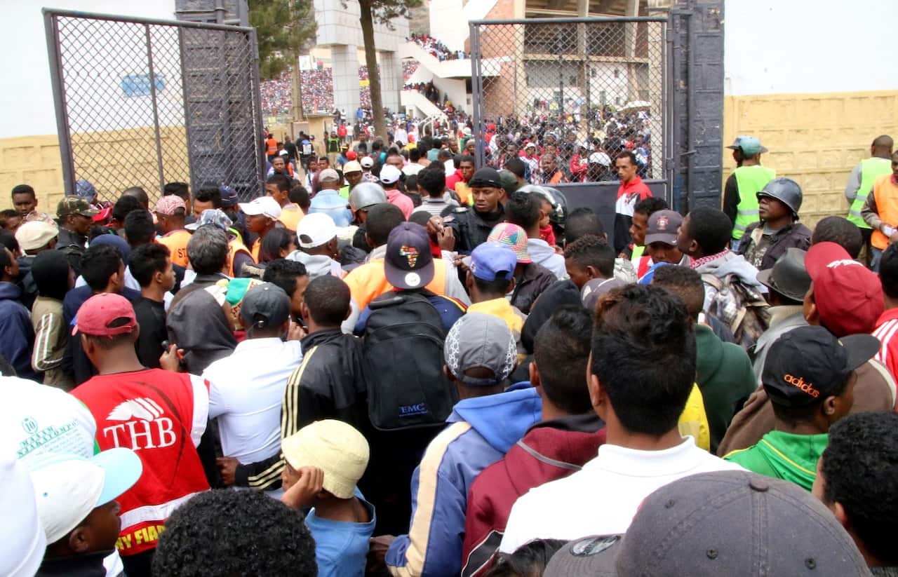 Malagasy people queue outside a football stadium waiting to enter and attend the African Cup of Nations qualifier match between Senegal and Madagascar