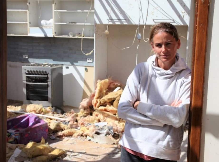 Michaela Simpson at a wrecked farmhouse, on the property.