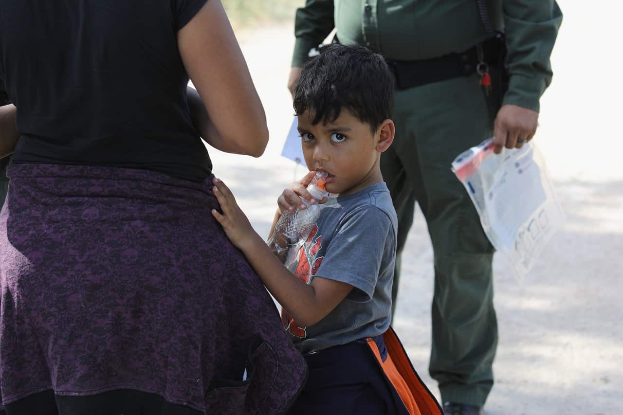 Border patrol agents detain asylum seekers, including children, near McAllen, Texas.