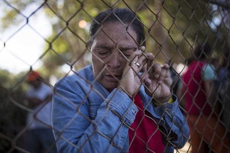 A woman, part of the caravan of Central American migrants hoping to reach the U.S. border, prays at a temporary shelter in Tijuana, Mexico.Mr Trump cited an overwhelmed immigration system for his recent proclamation that officials will only process asylum