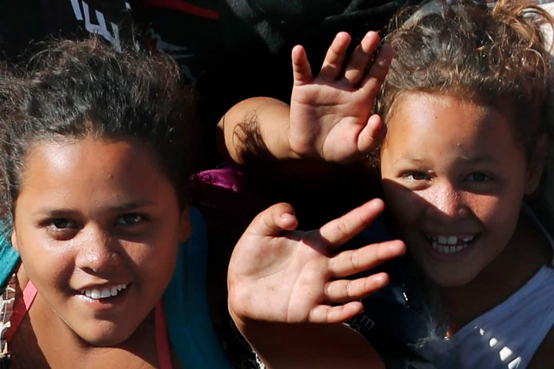 Central American migrant children wave as they make their way towards the US border. 