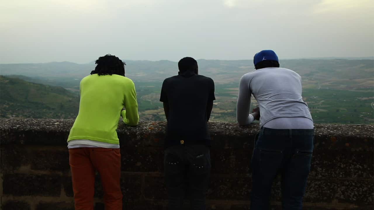 The migrants survived a shipping disaster that killed over 800. Because they're seeking asylum, they didn't want to show their faces.