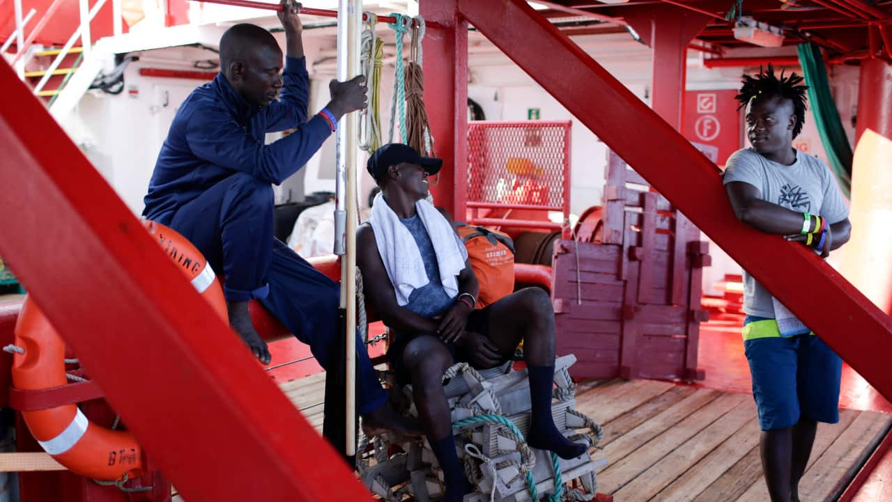 Migrants talk to each other aboard the Ocean Viking in the Mediterranean Sea, 14 September 2019.
