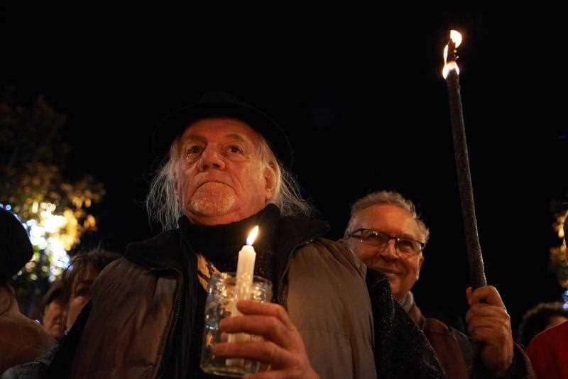 People hold candles for migrants as part of UN International Migrants Day last week in France.