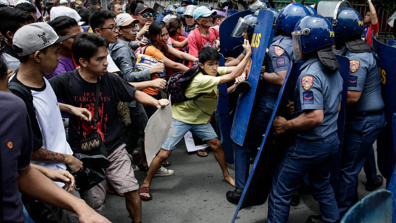 Activists clash with riot police during a protest against the declaration of martial law in Manila, Philippines on 4/7/17.