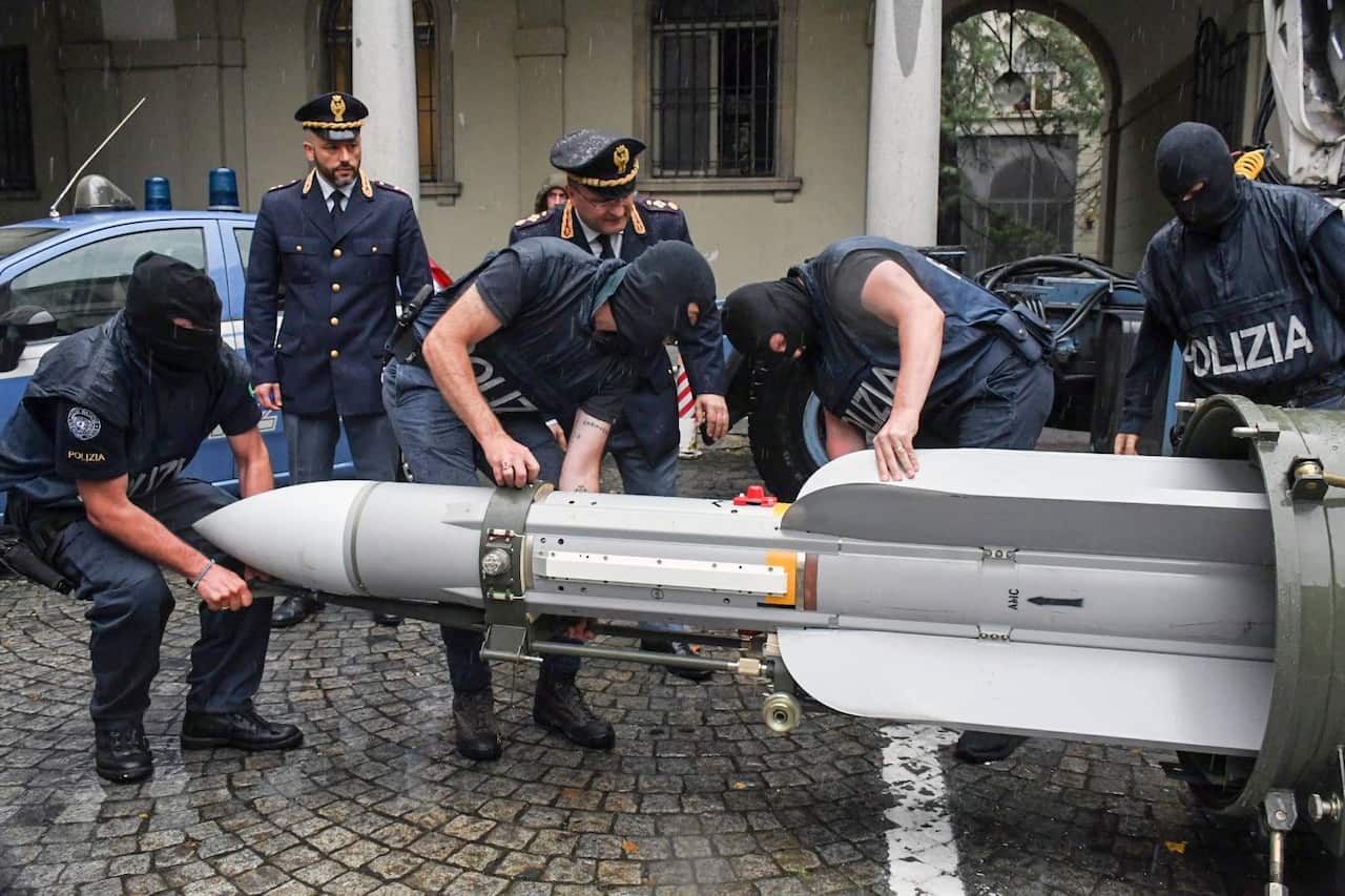 Special Forces of the anti-terrorist police officers inspect the air-to-air missile seized during the operation.