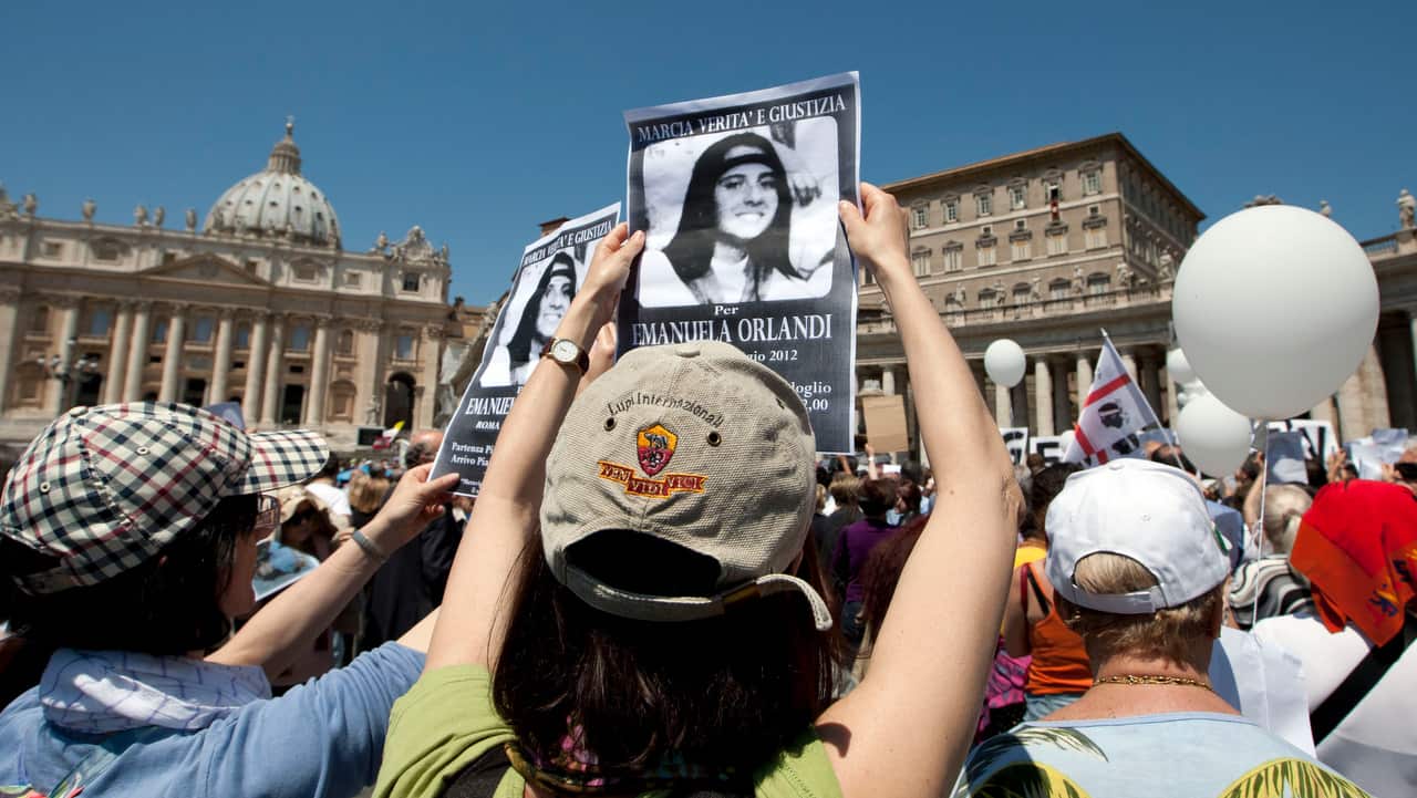 People hold pictures of Emanuela Orlandi reading, "march for truth and justice for Emanuela" in St. Peter's square, at the Vatican.
