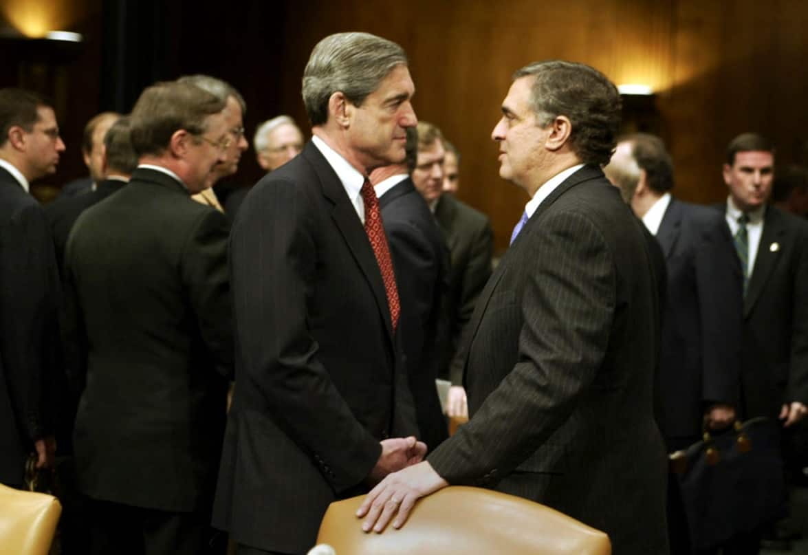 FILE -- Robert Mueller, left, the FBI director, and George Tenet, the CIA director, speak before a Senate Armed Services hearing in 2003