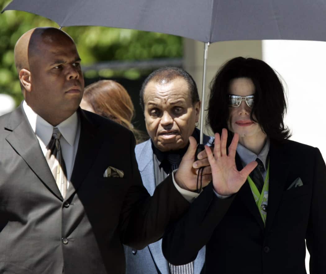 Pop star Michael Jackson, right, departs Santa Barbara County Courthouse with his father, Joe Jackson, center, and a bodyguard in 2005