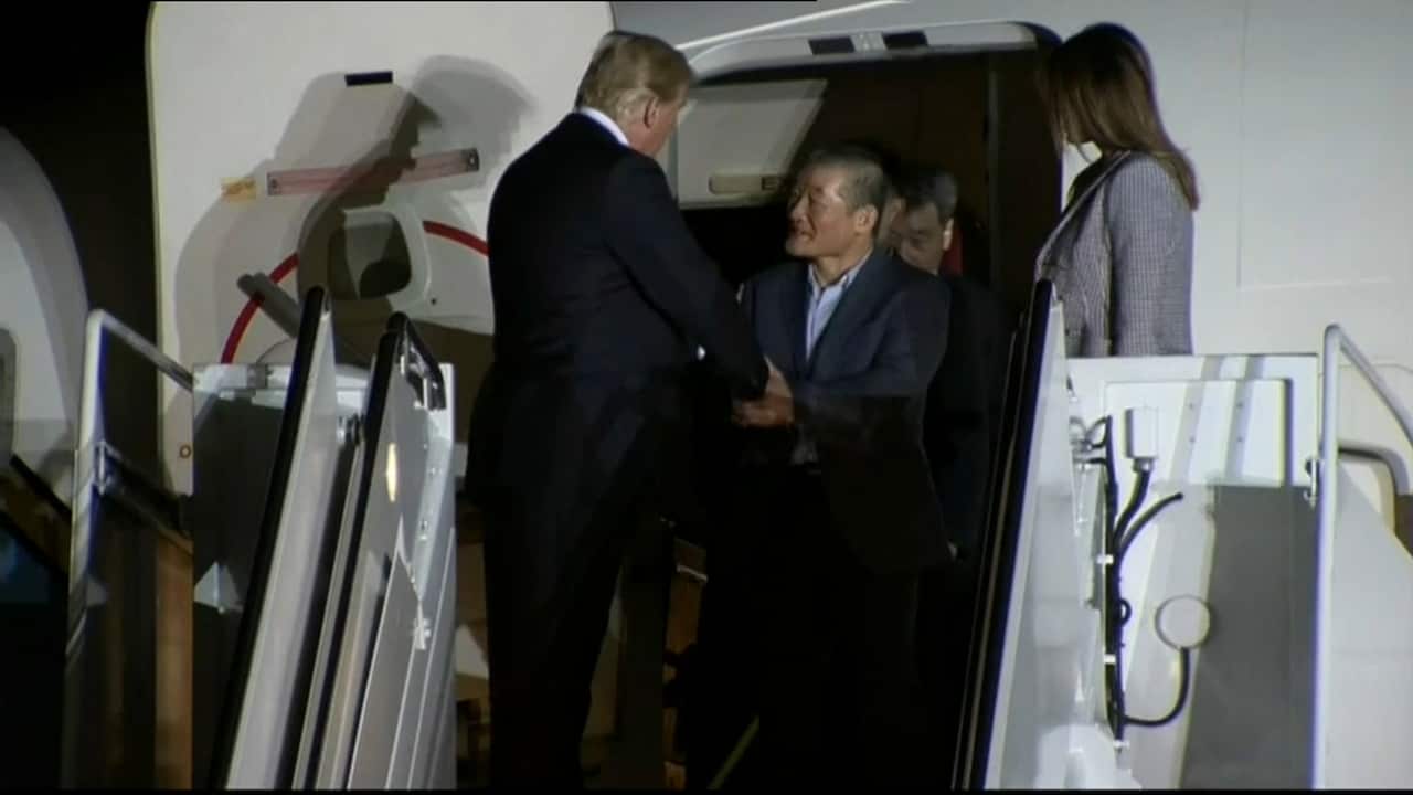 Trump shaking hands with one of the former North Korean detainees.
